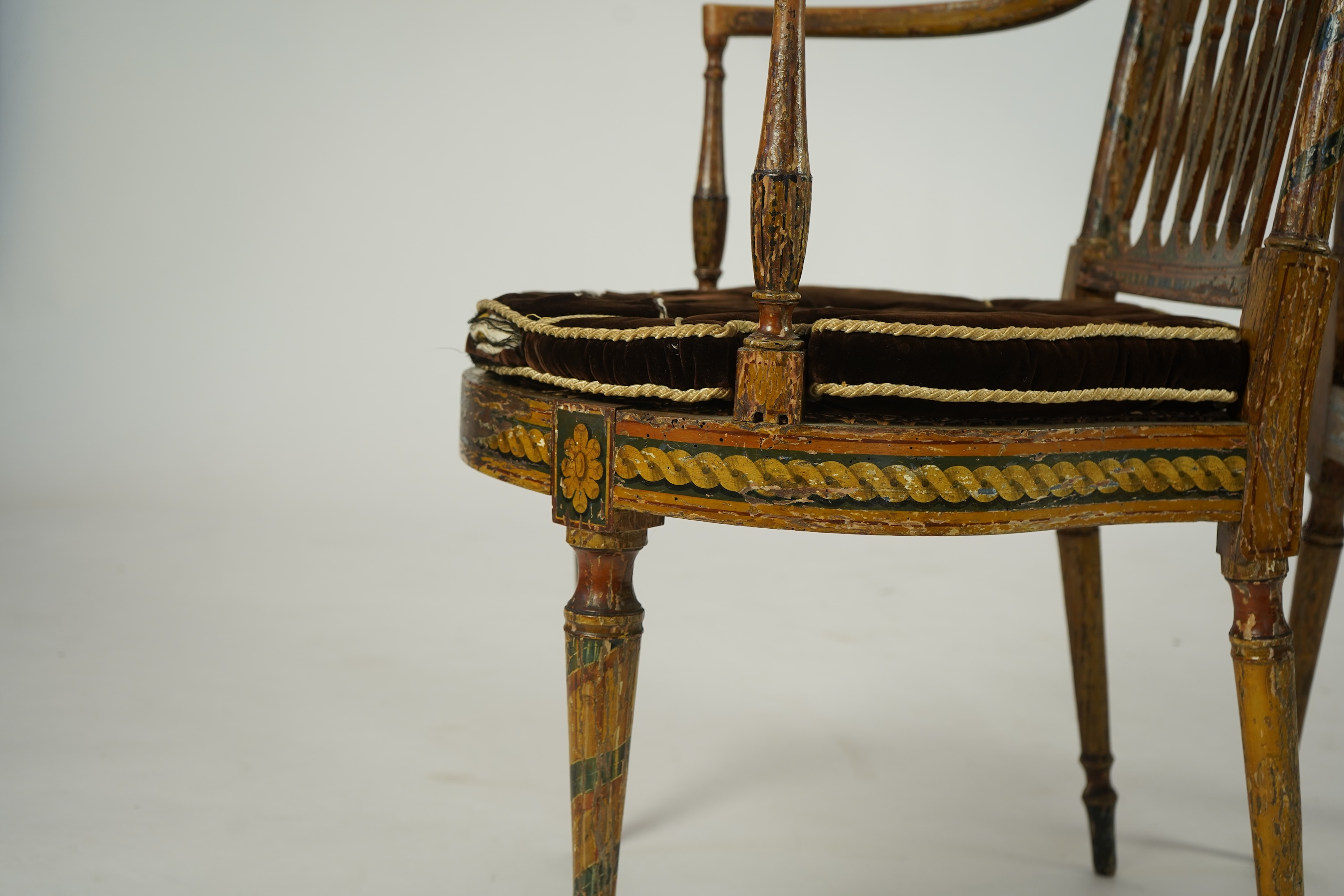 A set of six Sheraton period painted decorated cane seat elbow chairs